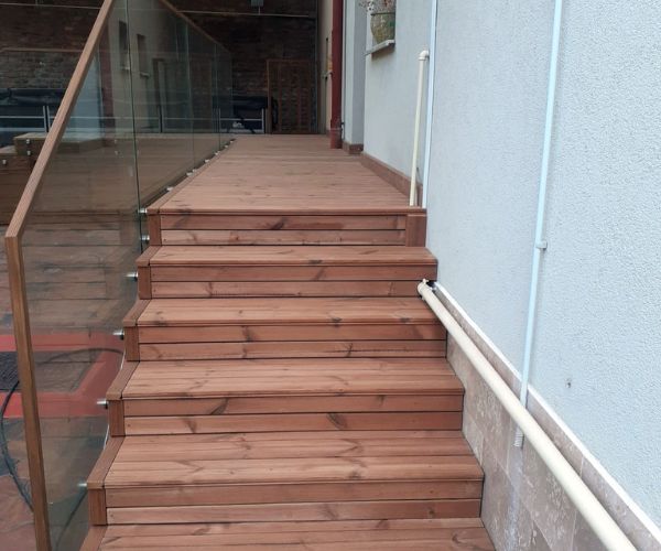 Escalier extérieur en bois avec garde-corps en verre Doxar