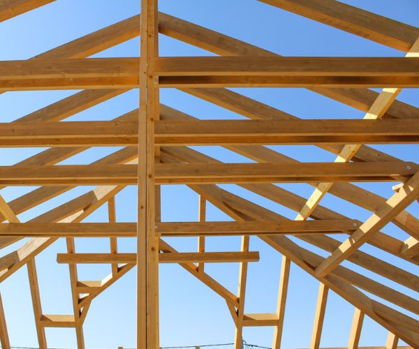 Structure de charpente bois apparente sur chantier, réalisée par Doxar France.